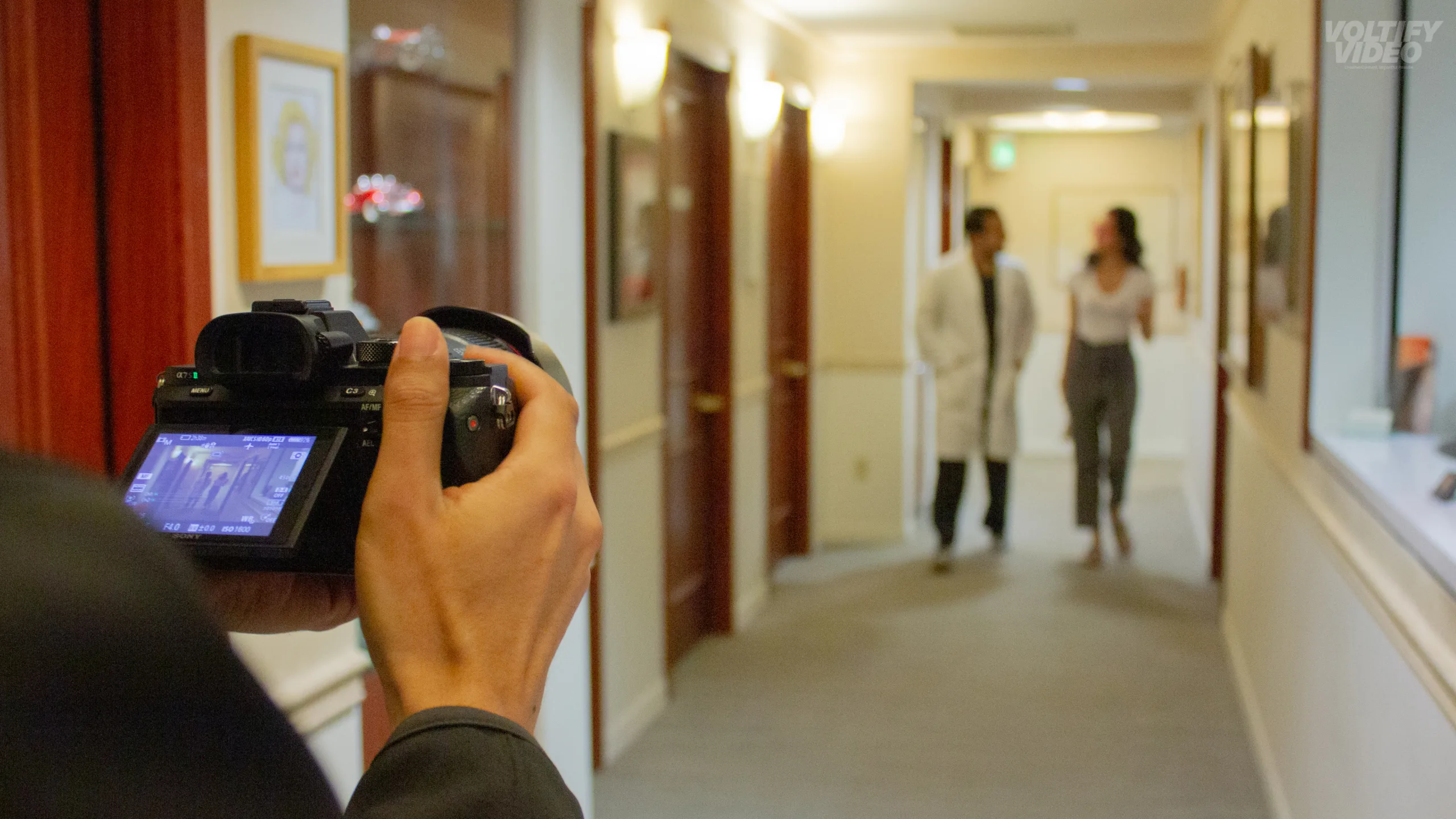 Filming Doctor and patient walking down the hall